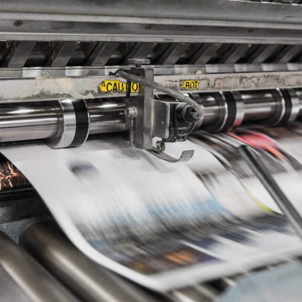 A news printer with a fast moving paper going through it